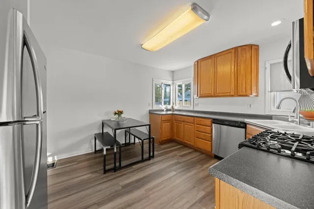 a kitchen with a sink appliances and cabinets