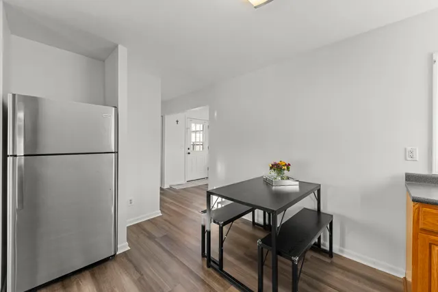 a dining room with furniture and wooden floor