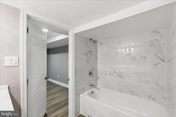 a bathroom with bathtub and shower