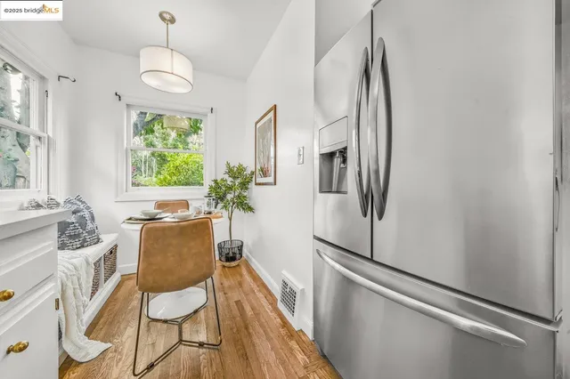 a dining room with furniture a window and wooden floor