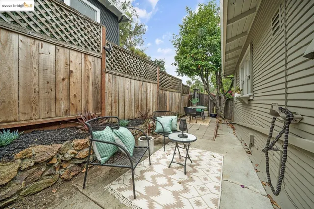 a view of backyard with a chair and potted plants