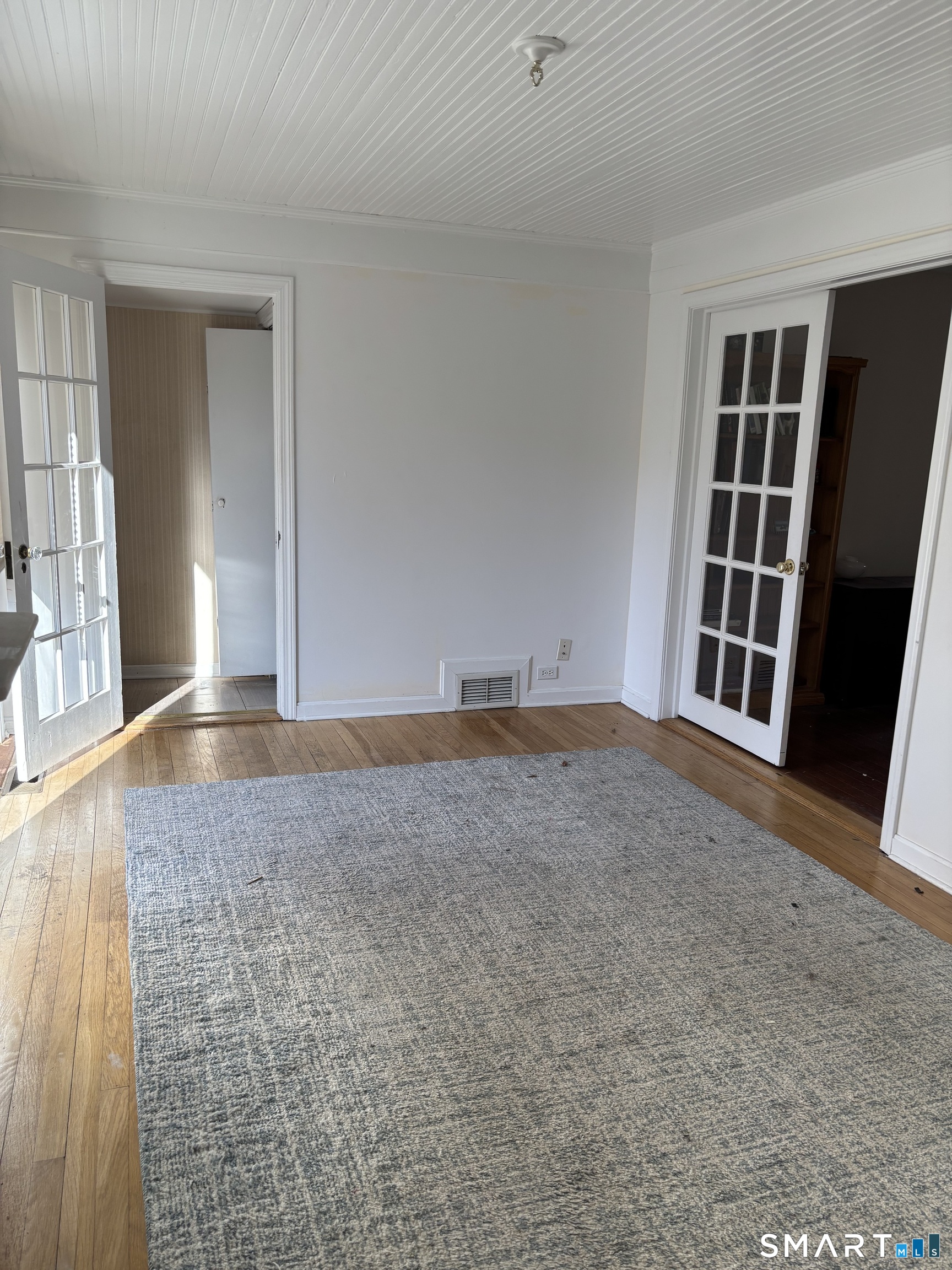 41 Sunrise Avenue Niantic, CT 06357 - Photo 13 of 15 a view of an empty room with wooden floor and a window
