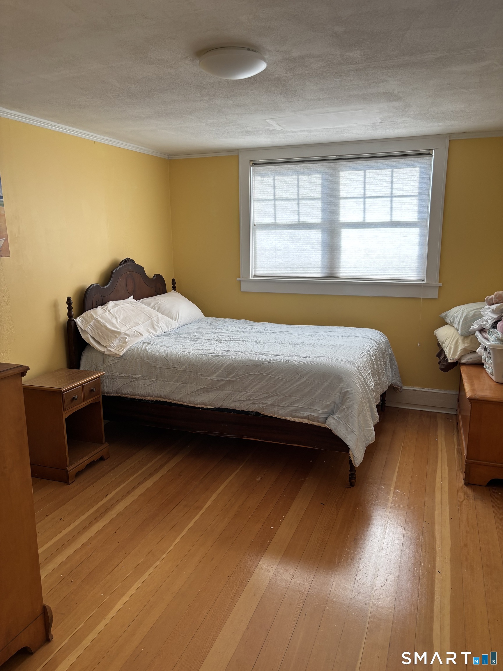41 Sunrise Avenue Niantic, CT 06357 - Photo 5 of 15 a bedroom with a bed and wooden floor
