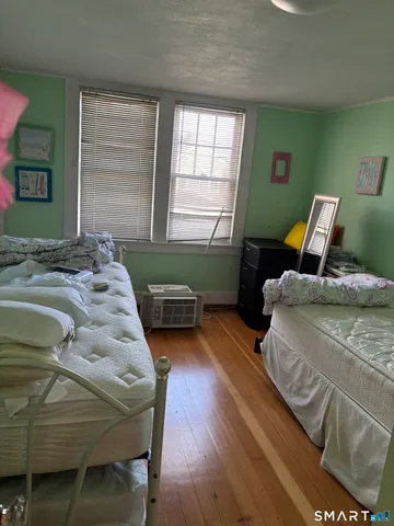 a bedroom with a bed and windows