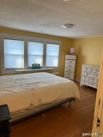 a bedroom with a bed and a night stand