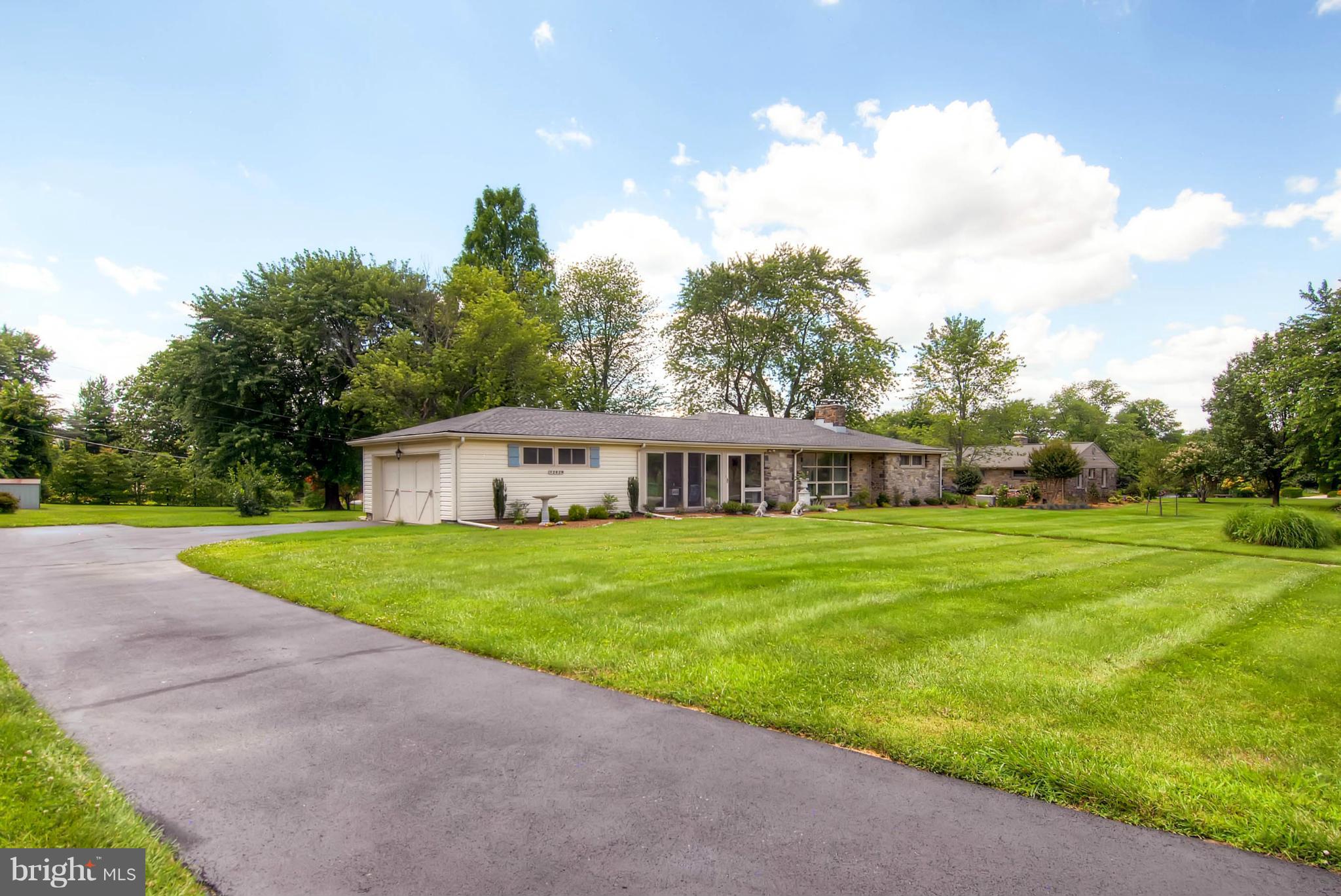 1202 Windy Gate Road Towson, MD 21286 - Photo 2 of 29 a view of a big house with a big yard and potted plants