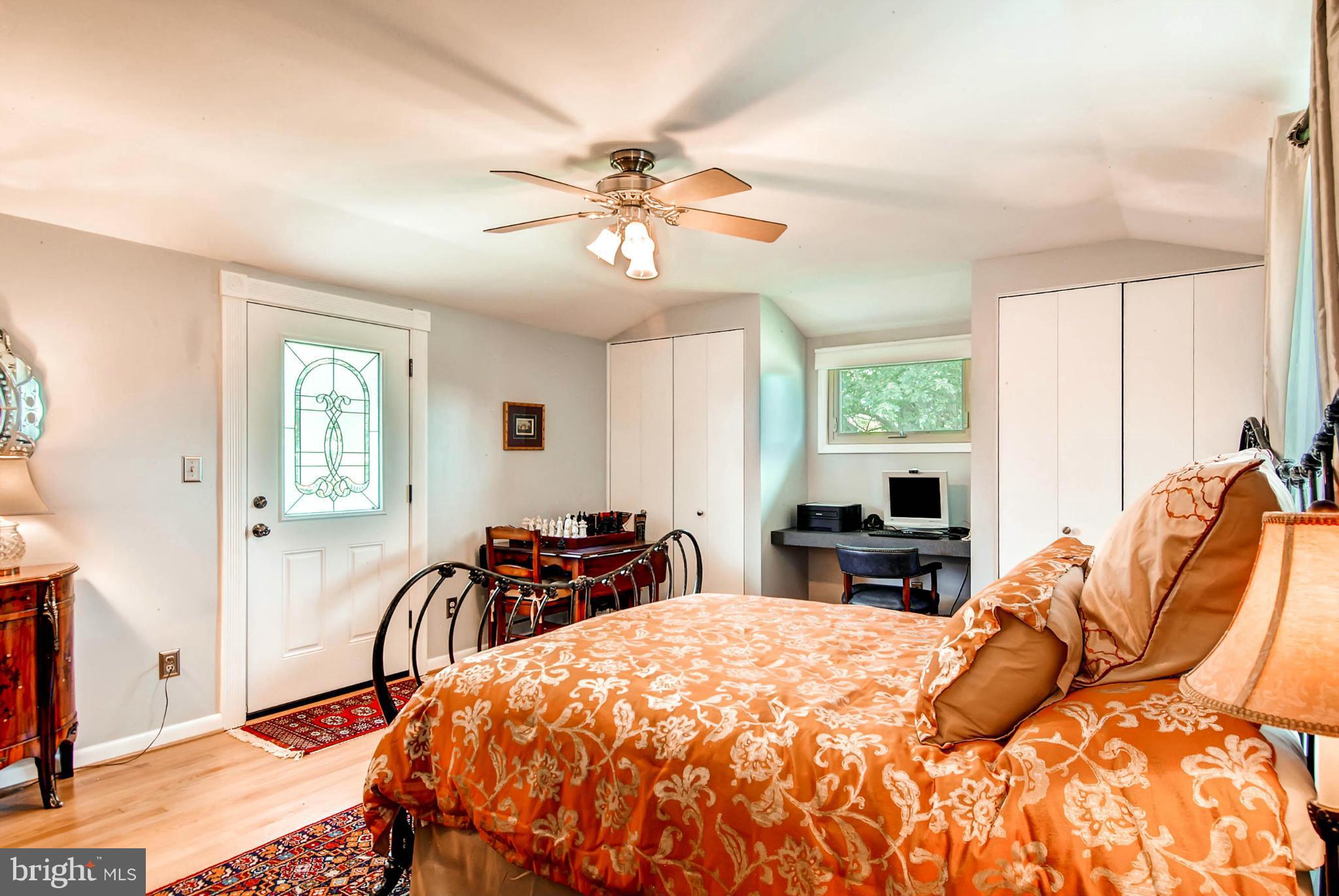 1202 Windy Gate Road Towson, MD 21286 - Photo 15 of 29 a bedroom with a bed and wooden floor