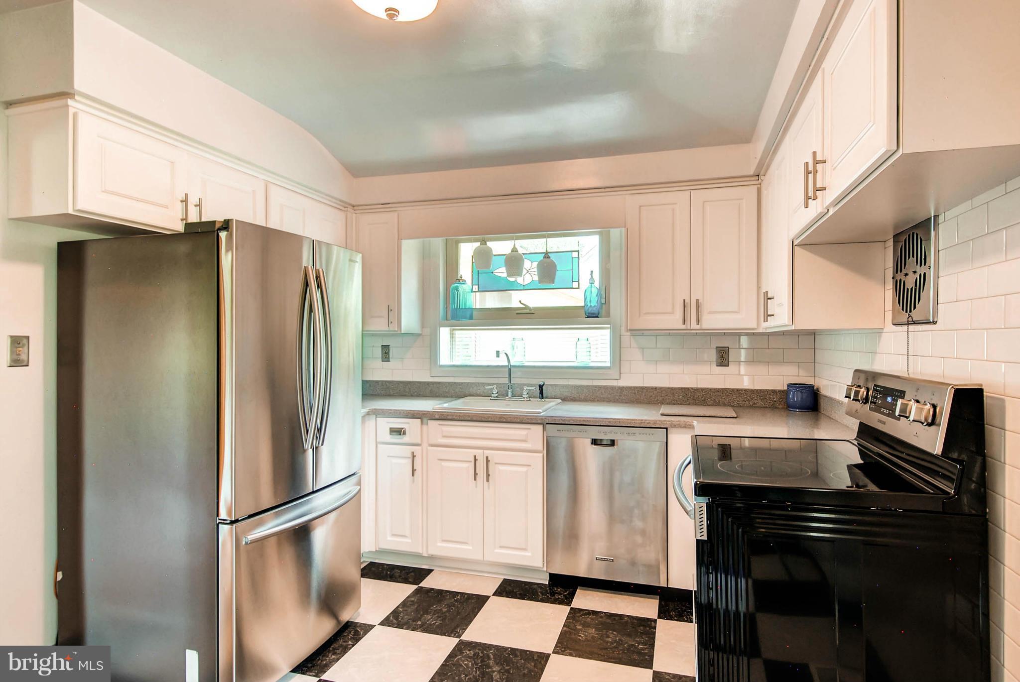 1202 Windy Gate Road Towson, MD 21286 - Photo 10 of 29 a kitchen with stainless steel appliances a refrigerator sink and stove