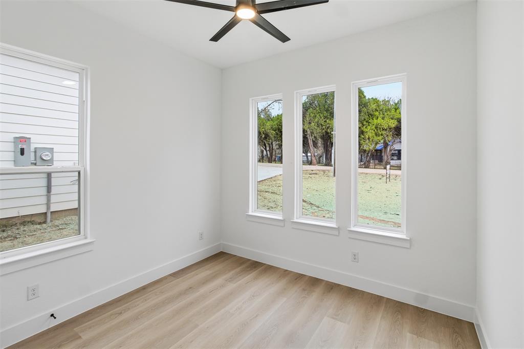 1119 Riverwood Road Dallas, TX 75217 - Photo 11 of 32 Spare room featuring light wood-style floors and ceiling fan