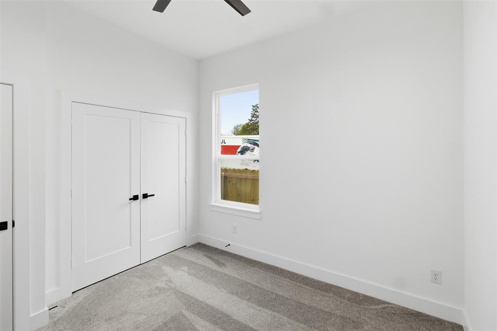 1119 Riverwood Road Dallas, TX 75217 - Photo 15 of 32 Unfurnished bedroom featuring carpet flooring, a closet, and a ceiling fan