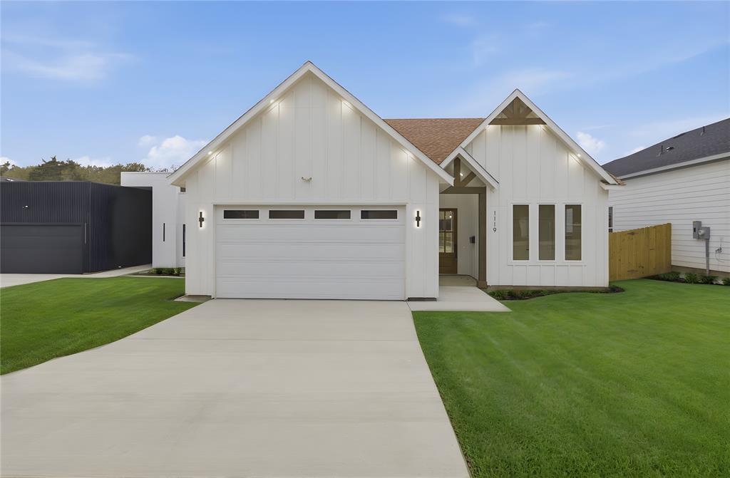 1119 Riverwood Road Dallas, TX 75217 - Photo 2 of 32 Modern farmhouse style home featuring board and batten siding, driveway, and a garage