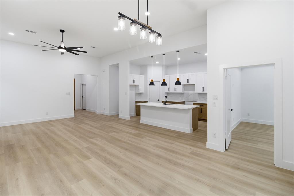 1119 Riverwood Road Dallas, TX 75217 - Photo 5 of 32 Unfurnished living room featuring light wood finished floors, a ceiling fan, and recessed lighting