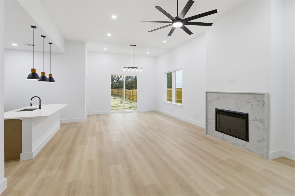 1119 Riverwood Road Dallas, TX 75217 - Photo 8 of 32 Unfurnished living room featuring a fireplace, light wood finished floors, recessed lighting, and ceiling fan