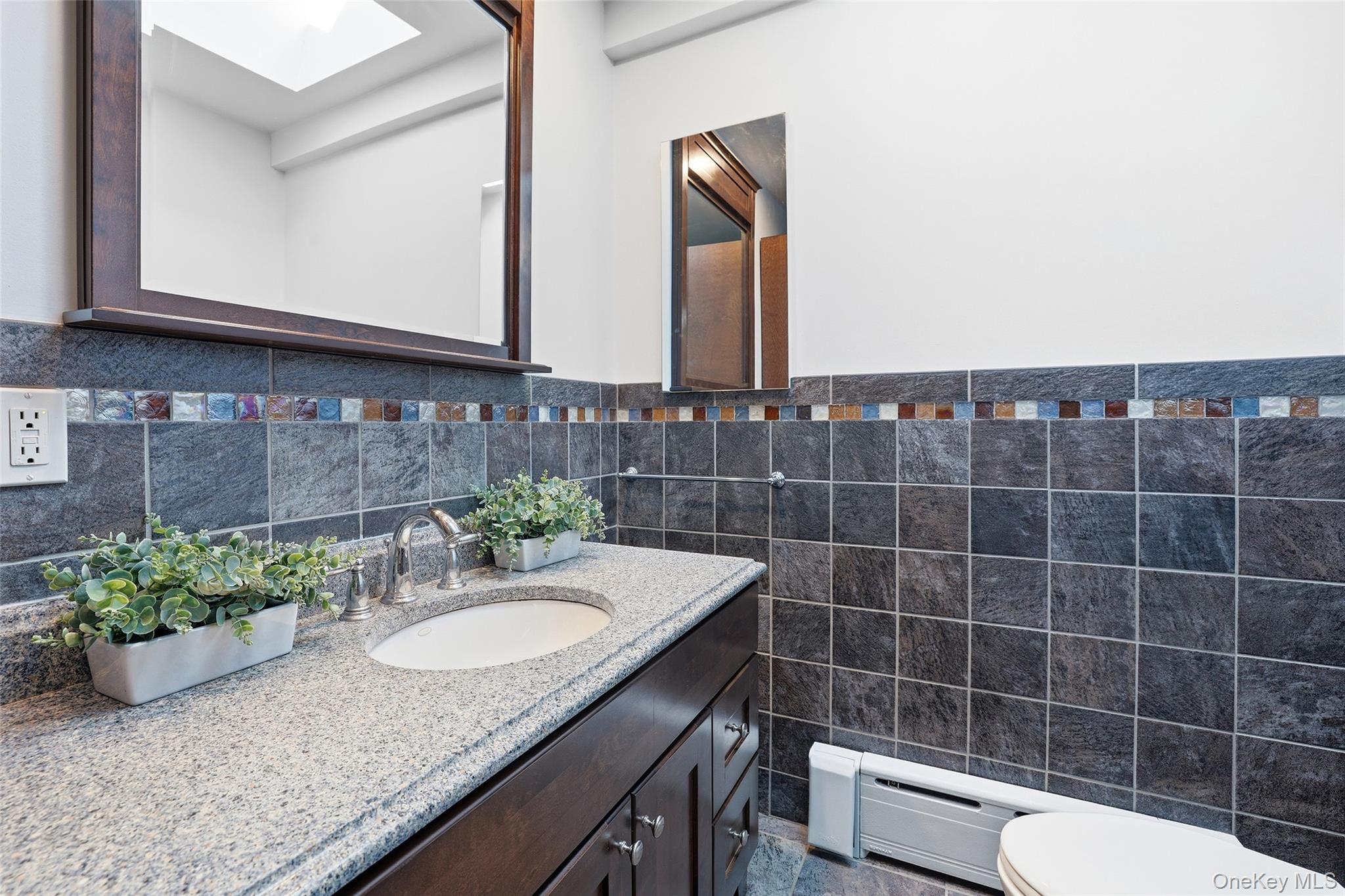 331 Old Colony Road Hartsdale, NY 10530 - Photo 19 of 45 a bathroom with a granite countertop sink a mirror and a toilet