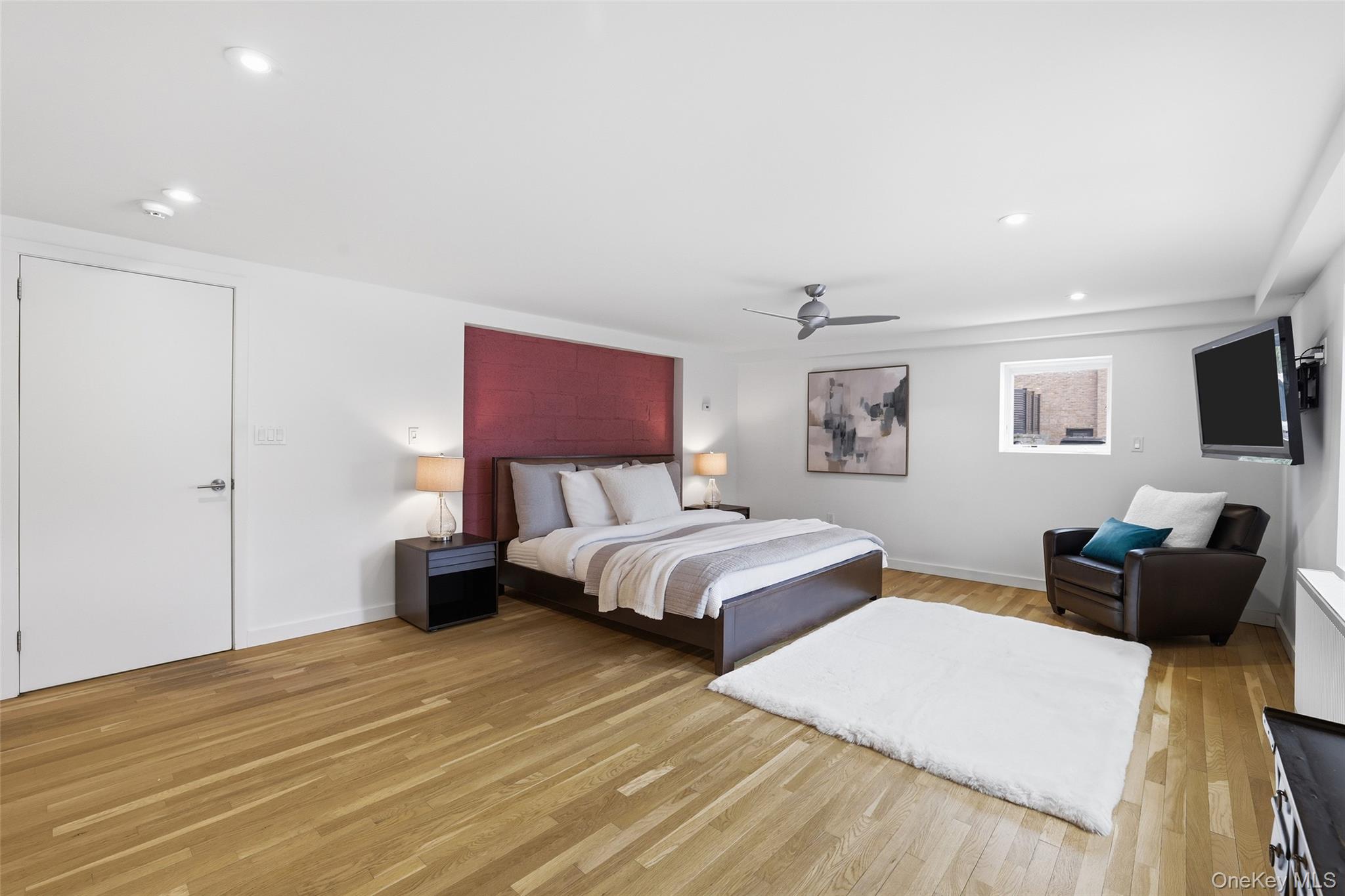 331 Old Colony Road Hartsdale, NY 10530 - Photo 27 of 45 a spacious bedroom with a bed and a couch