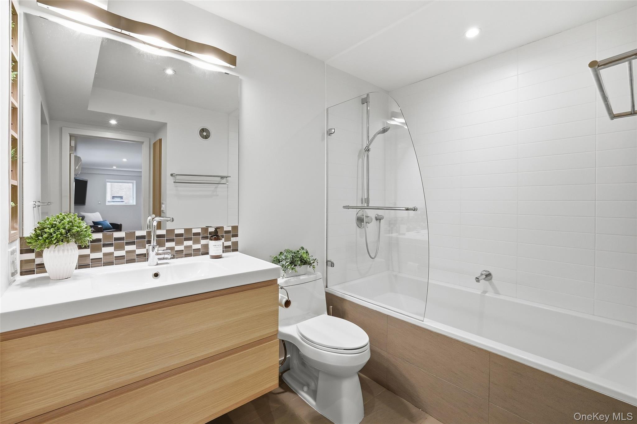 331 Old Colony Road Hartsdale, NY 10530 - Photo 29 of 45 a bathroom with a sink mirror toilet and bathtub