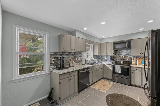 a kitchen with a sink stove and refrigerator
