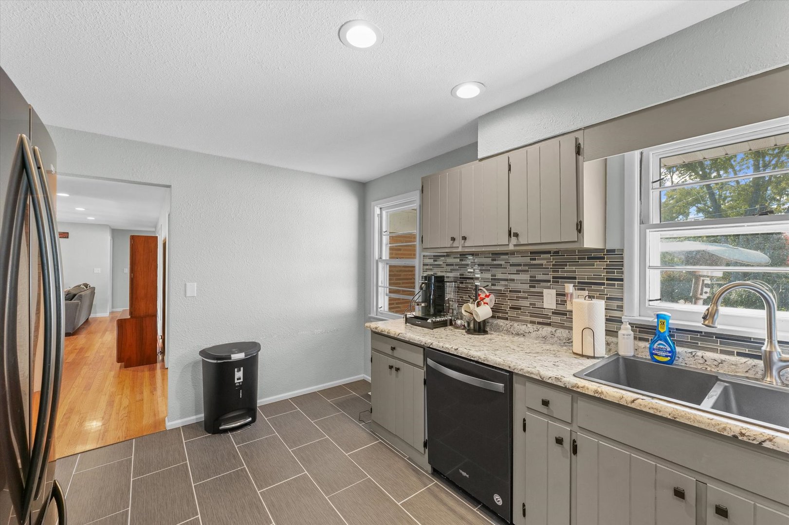 1609 West John Street Champaign, IL 61821 - Photo 13 of 30 a kitchen with stainless steel appliances granite countertop a sink stove and refrigerator