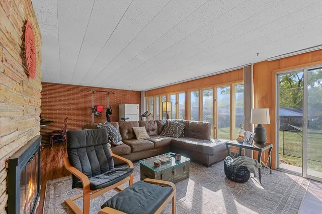 a living room with furniture and a floor to ceiling window