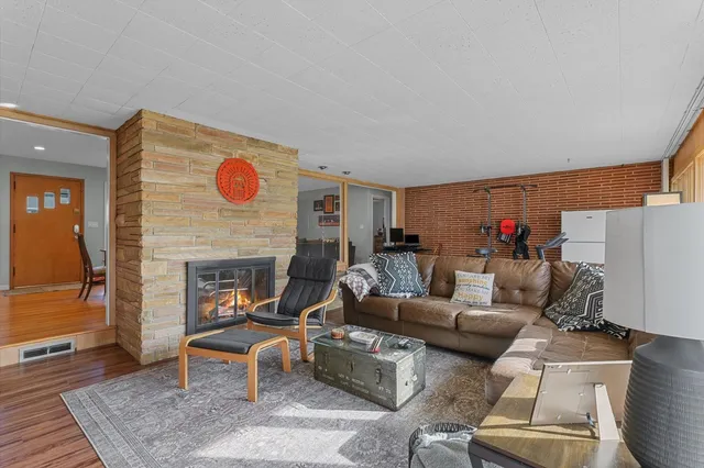 a living room with furniture and a fireplace