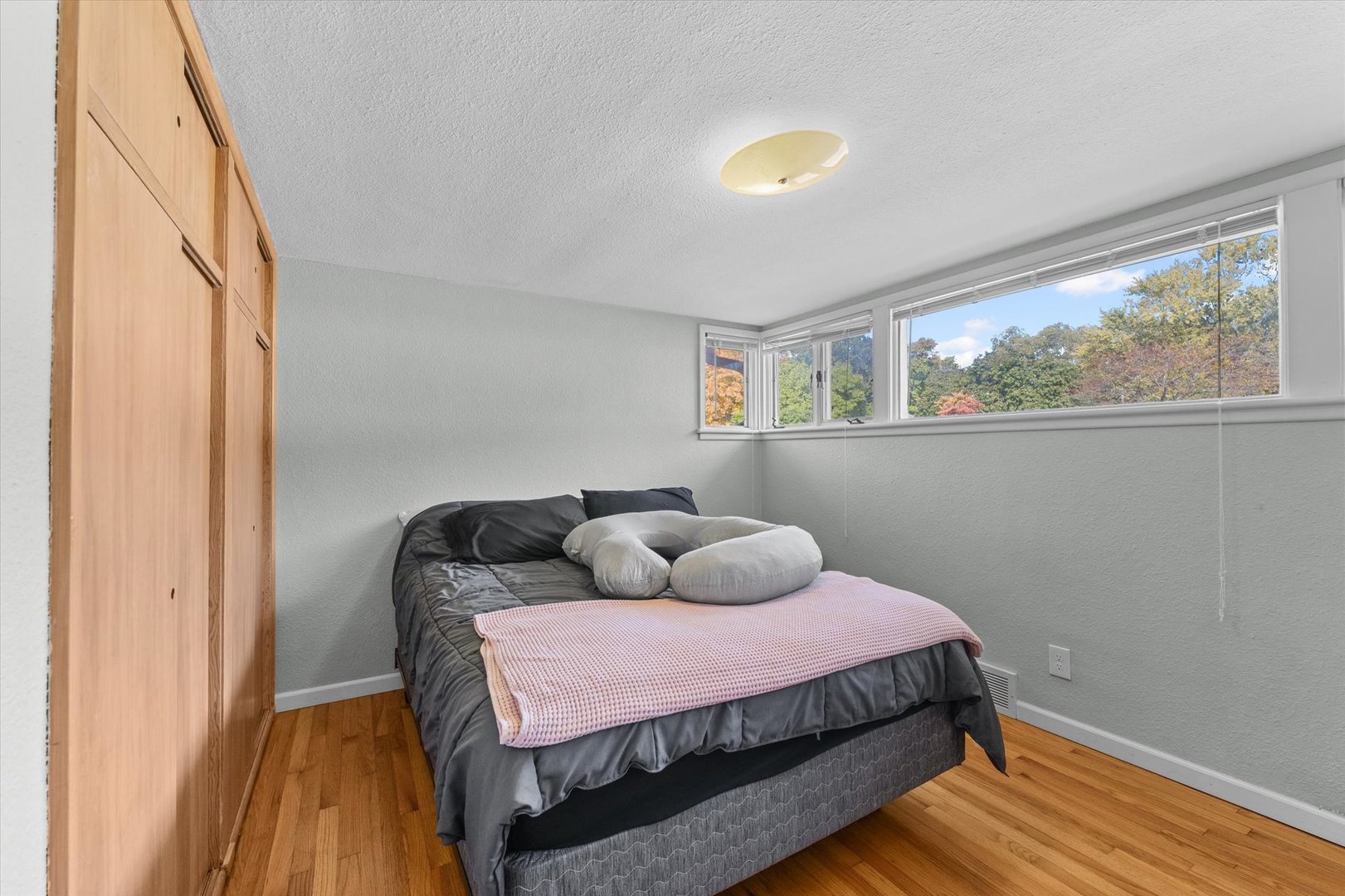1609 West John Street Champaign, IL 61821 - Photo 20 of 30 a bedroom with a bed and wooden floor