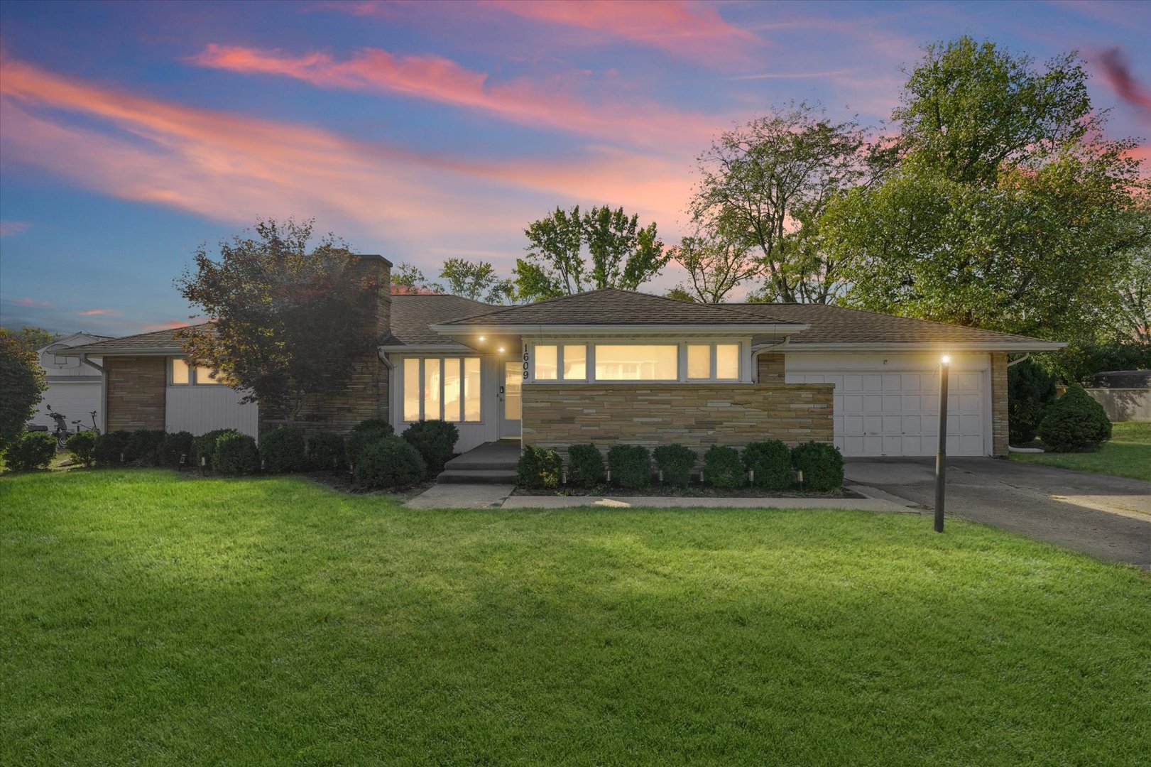 1609 West John Street Champaign, IL 61821 - Photo 2 of 30 a view of a backyard with a garden and plants