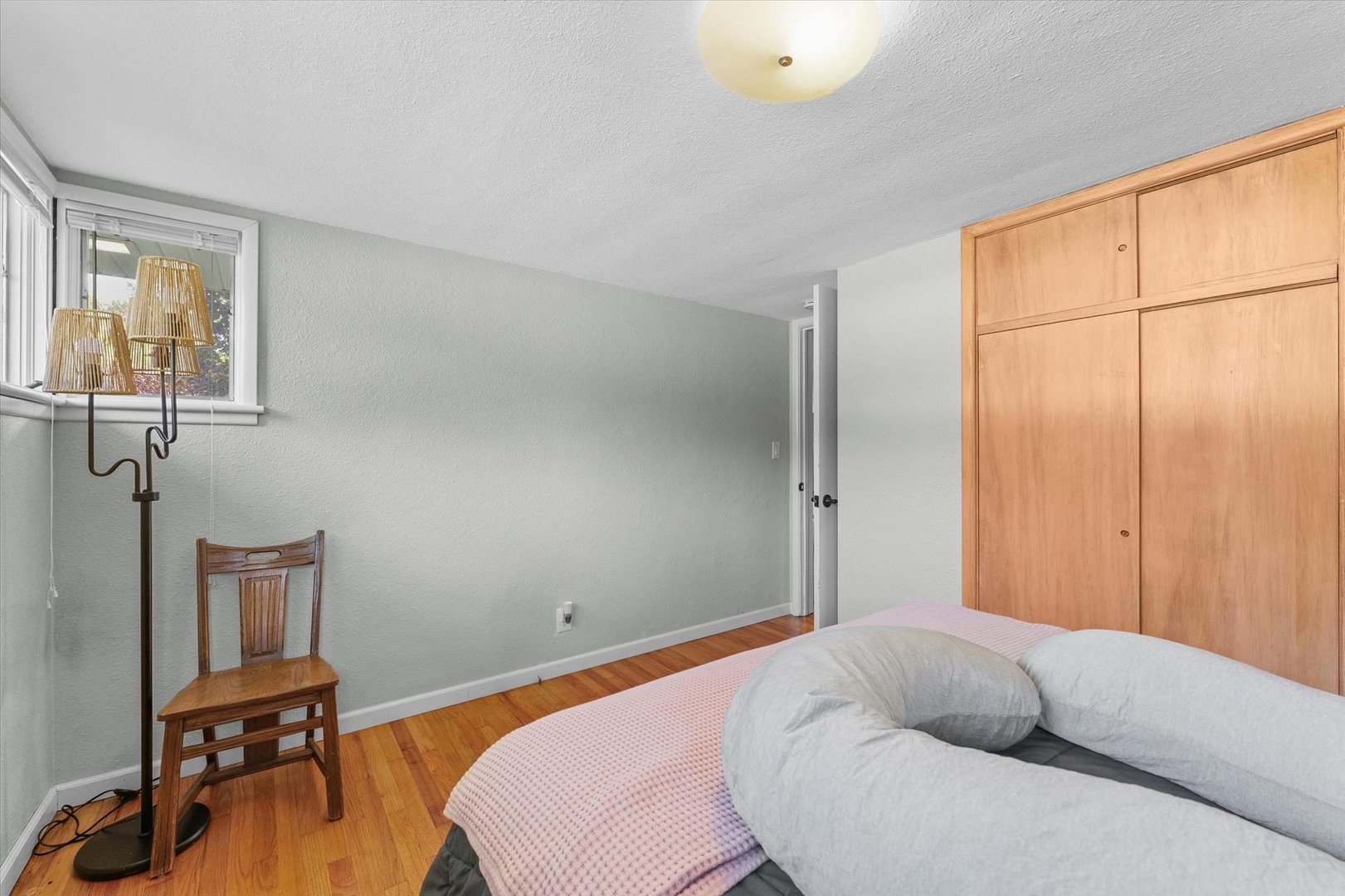 1609 West John Street Champaign, IL 61821 - Photo 21 of 30 a bedroom with a bed and a table in it