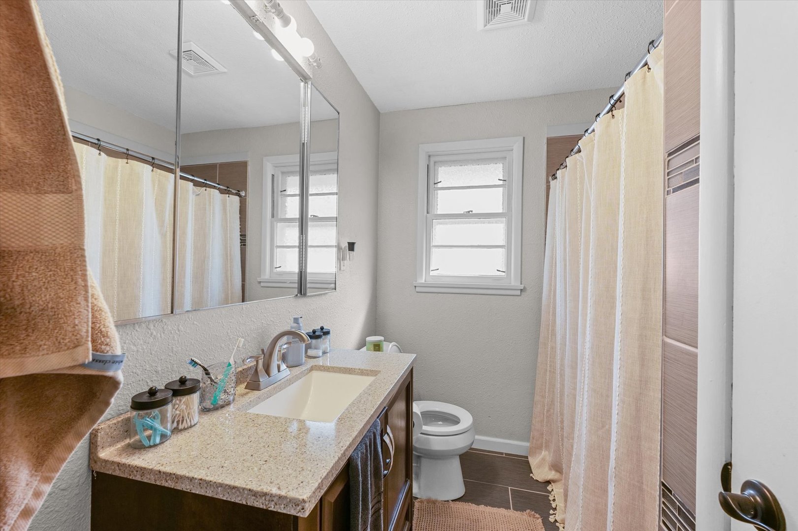 1609 West John Street Champaign, IL 61821 - Photo 24 of 30 a bathroom with a sink toilet and shower