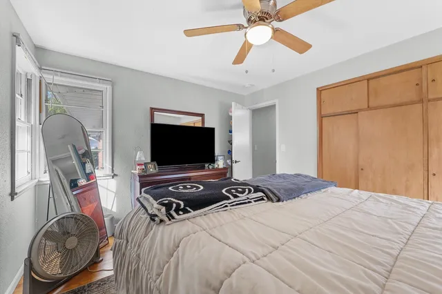 a bedroom with a bed and a flat screen tv