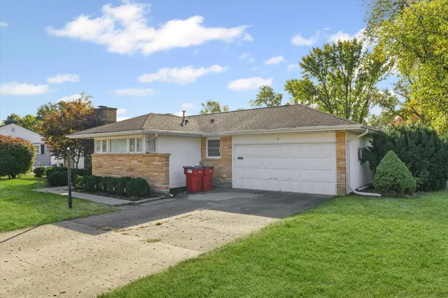 a view of a house with a yard and garage