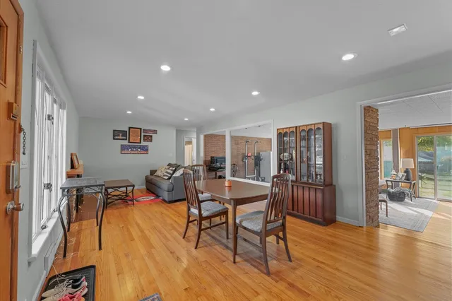 a dining room with furniture and wooden floor