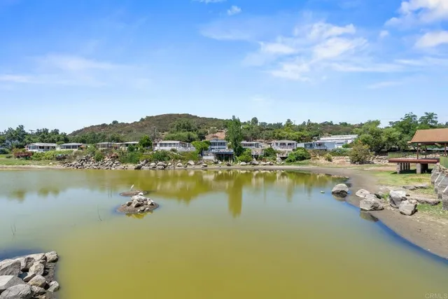 a view of a lake with houses in the back