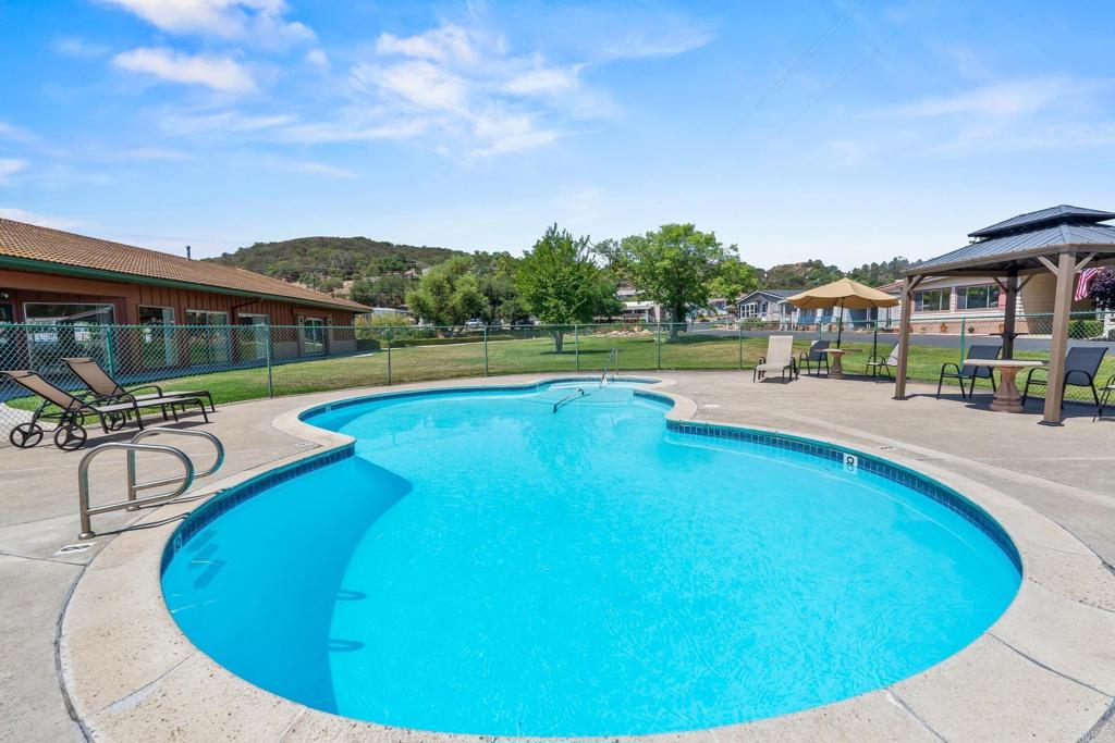 28890 Lilac Road, Unit 119 Valley Center, CA 92082 - Photo 16 of 16 a view of a swimming pool with a lounge chairs