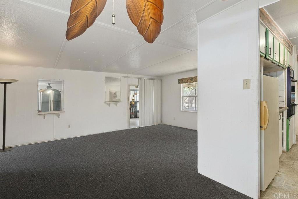 28890 Lilac Road, Unit 119 Valley Center, CA 92082 - Photo 6 of 16 a view of a livingroom with wooden floor and windows