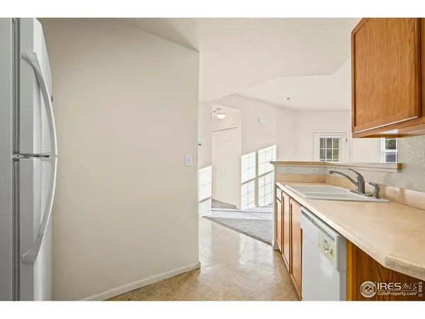 a kitchen with a sink and a refrigerator