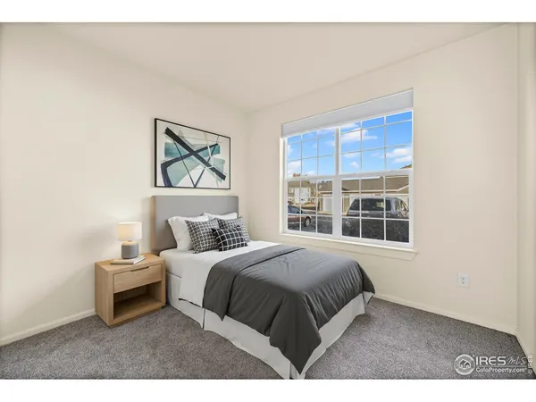 a bedroom with a large bed and a window