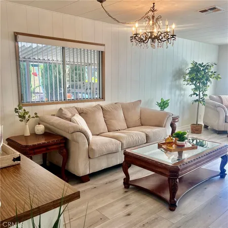 a living room with furniture and a chandelier
