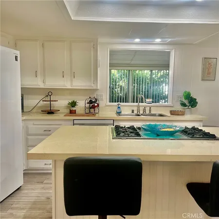 a kitchen with a sink and a stove top oven