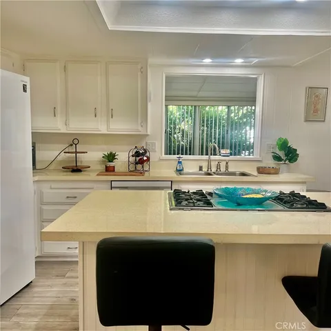 a kitchen with a sink and a stove top oven