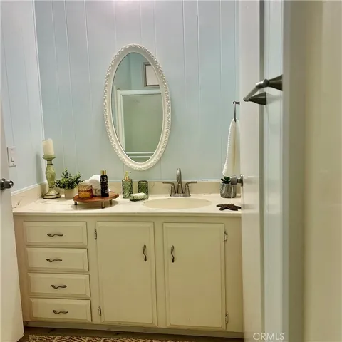 a bathroom with a double vanity sink and a mirror