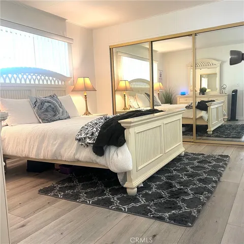 a living room with a bed furniture and next to a window