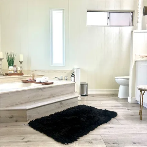 a bathroom with a black countertop sink and a toilet