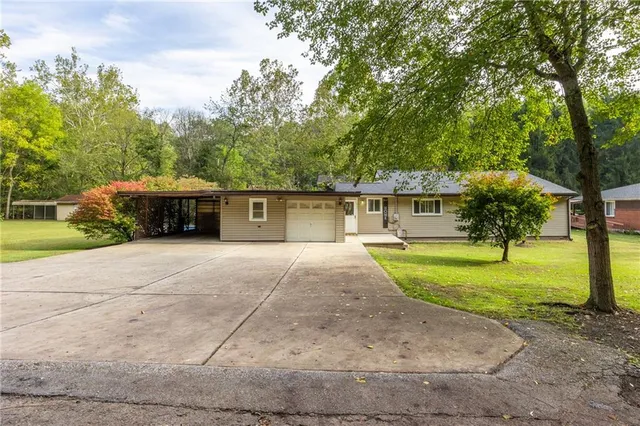 a front view of a house with a yard and a garage