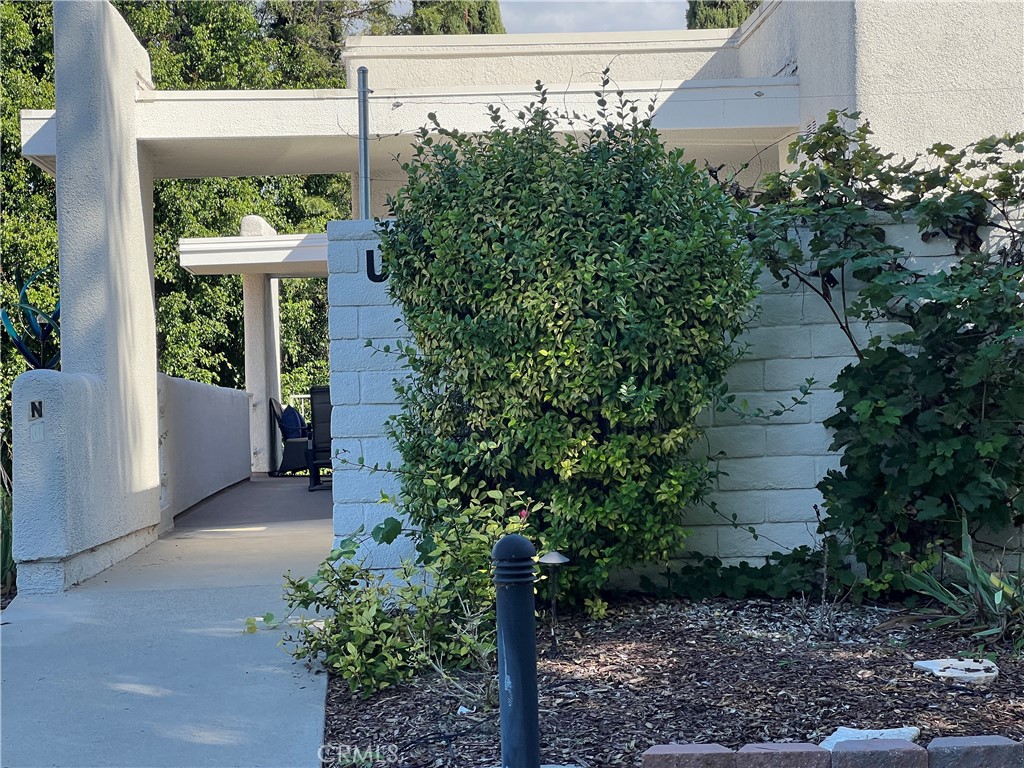 2121 Ronda Granada, Unit N Laguna Woods, CA 92637 - Photo 2 of 38 a front view of a house with a yard