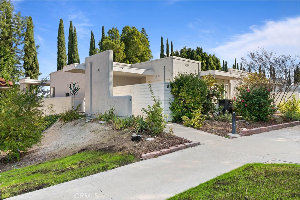 2121 Ronda Granada, Unit N Laguna Woods, CA 92637 - Photo 4 of 38 a view of a garden with tall buildings