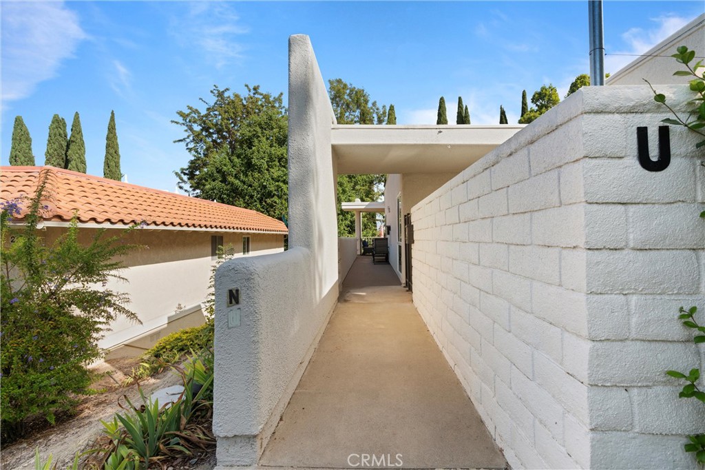 2121 Ronda Granada, Unit N Laguna Woods, CA 92637 - Photo 5 of 38 a view of a patio with table and chairs and potted plants