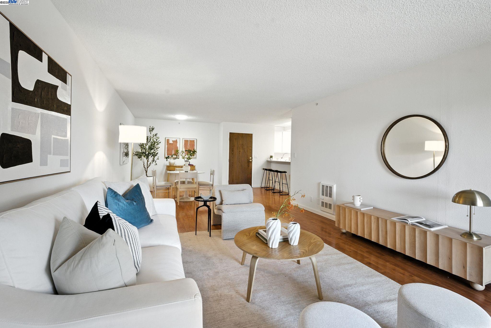 332 Philip Drive, Unit 303 Daly City, CA 94015 - Photo 3 of 55 a living room with furniture a mirror and a fireplace
