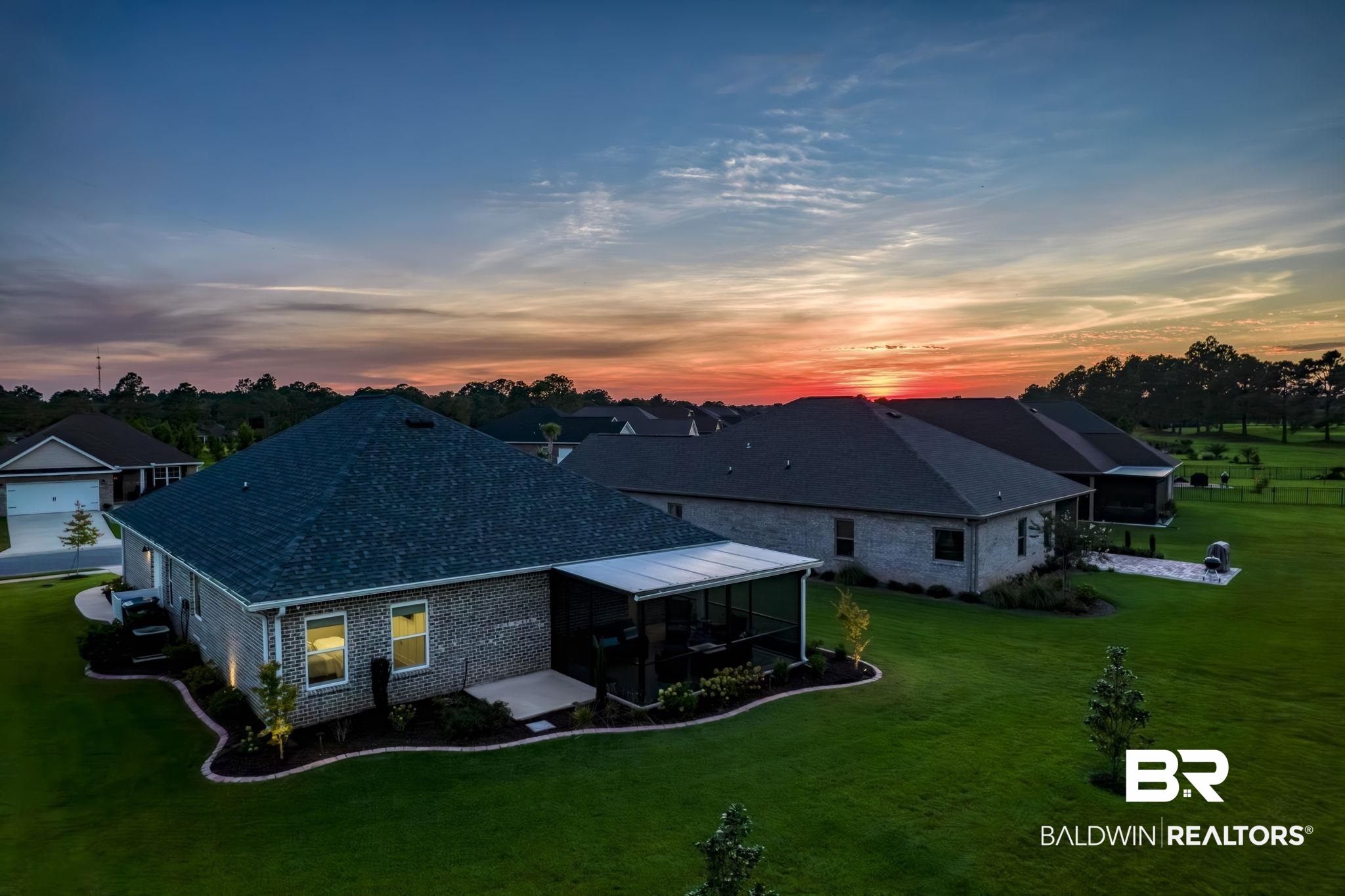 9815 Lakeview Drive Foley, AL 36535 - Photo 92 of 100 Back house at dusk featuring a garage and a yard