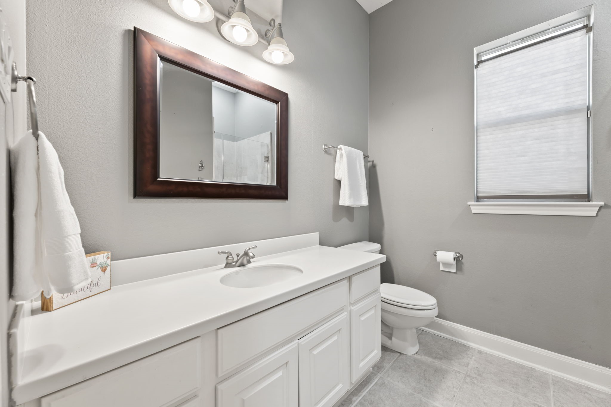 13506 Key Ridge Lane Cypress, TX 77429 - Photo 27 of 49 a bathroom with a toilet sink and mirror