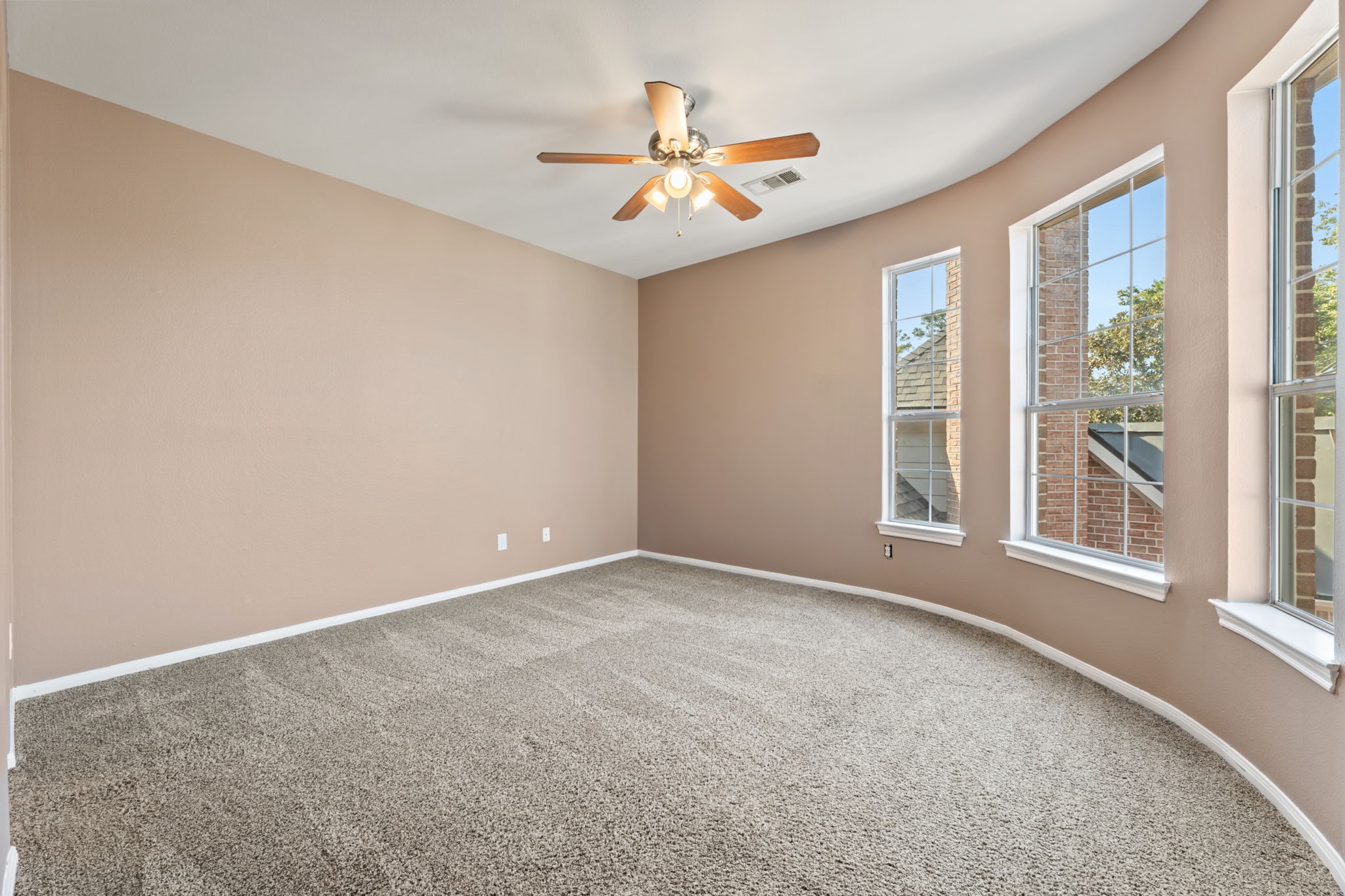 13506 Key Ridge Lane Cypress, TX 77429 - Photo 36 of 49 an empty room with windows and ceiling fan